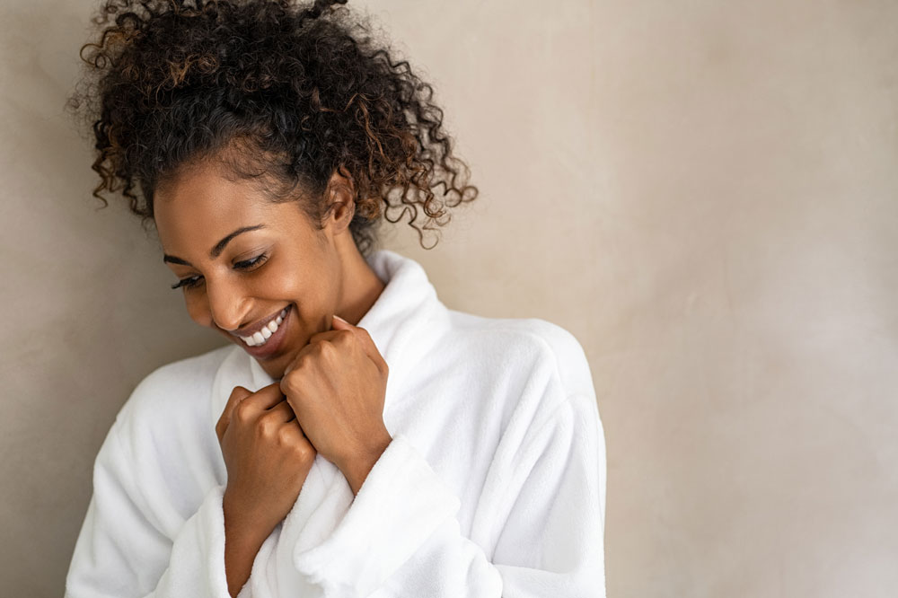 woman in white robe smiling